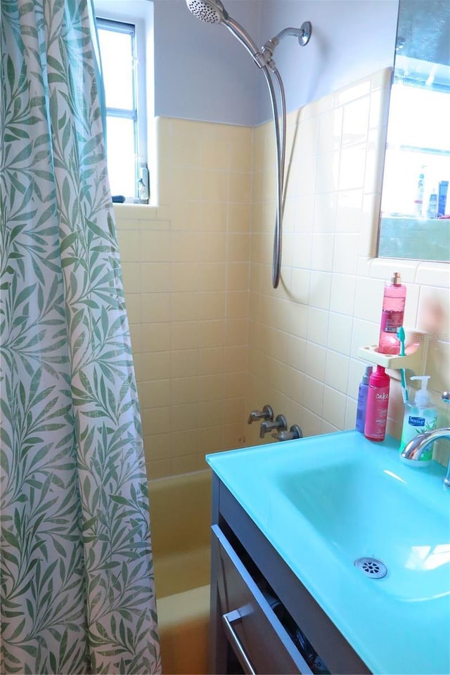 bathroom with vanity, shower / tub combo, and decorative backsplash