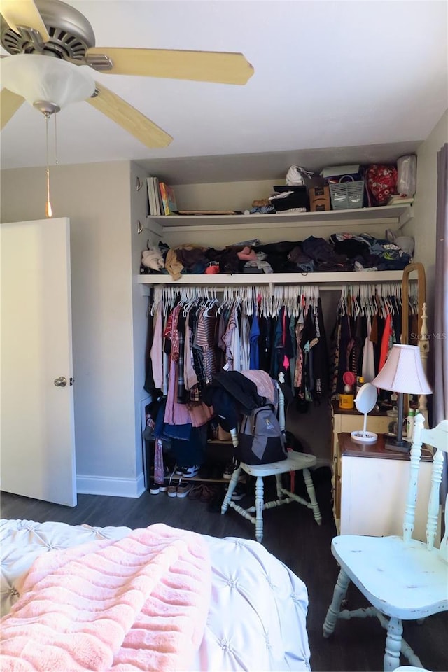 bedroom featuring dark wood-type flooring, a closet, and ceiling fan