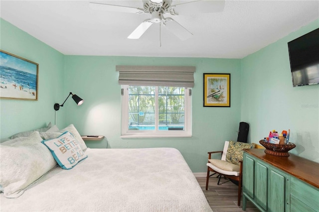 bedroom featuring hardwood / wood-style flooring and ceiling fan