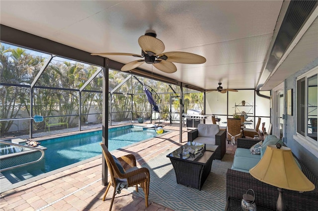 exterior space featuring ceiling fan, an outdoor hangout area, a patio area, and glass enclosure