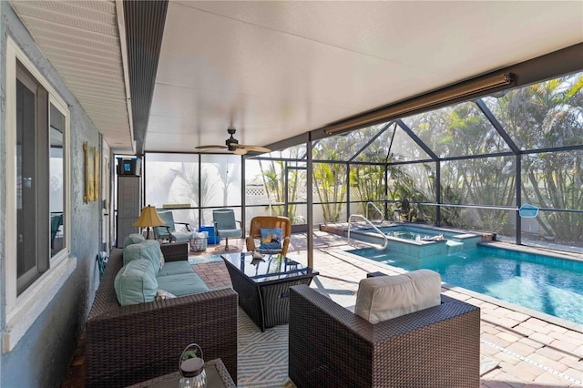 view of swimming pool featuring ceiling fan, outdoor lounge area, glass enclosure, a patio area, and an in ground hot tub