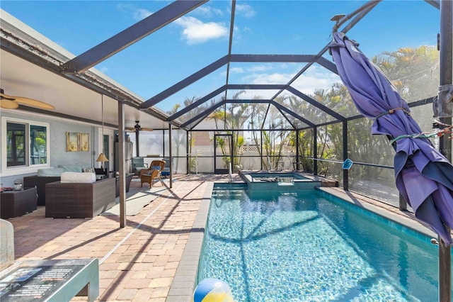 view of pool with a patio area, glass enclosure, outdoor lounge area, an in ground hot tub, and ceiling fan