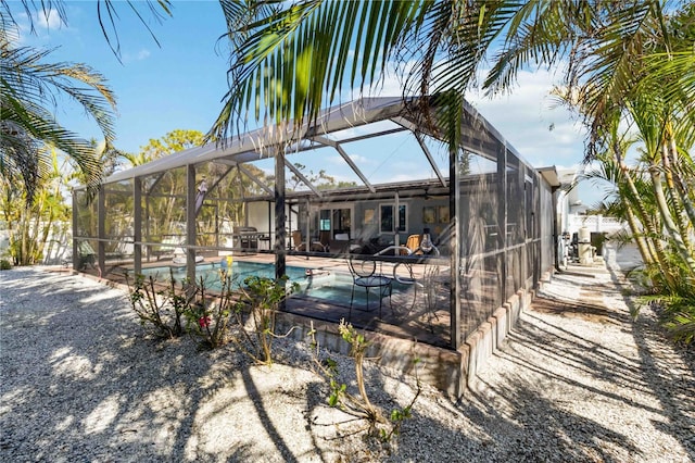 view of pool featuring a patio area and glass enclosure