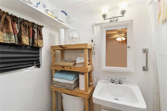 bathroom featuring sink, ceiling fan, and toilet