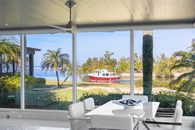 sunroom / solarium featuring a water view