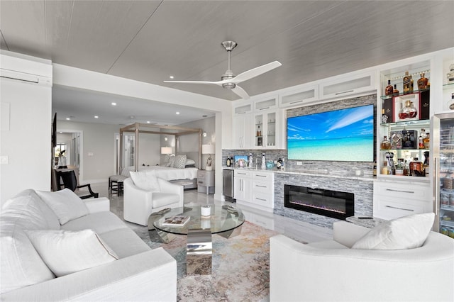 living room with ceiling fan, bar area, and an AC wall unit