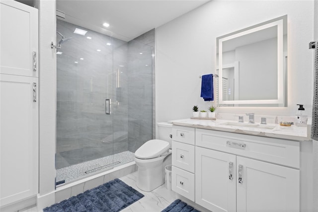 bathroom featuring vanity, toilet, and a shower with door