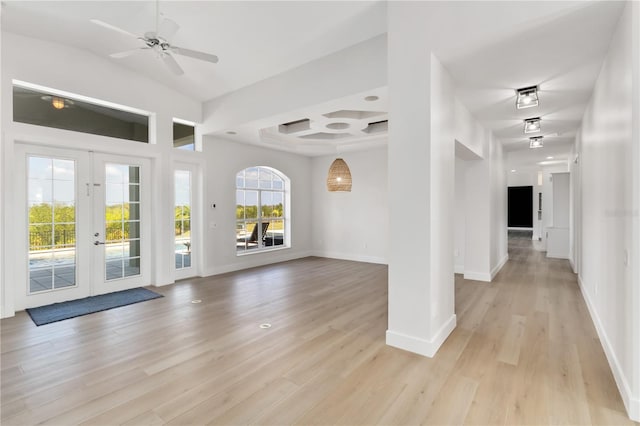 foyer with french doors, coffered ceiling, and light hardwood / wood-style flooring