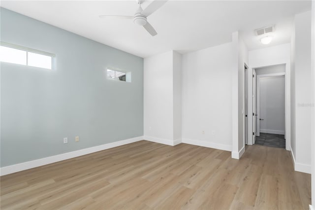 spare room with ceiling fan and light hardwood / wood-style floors