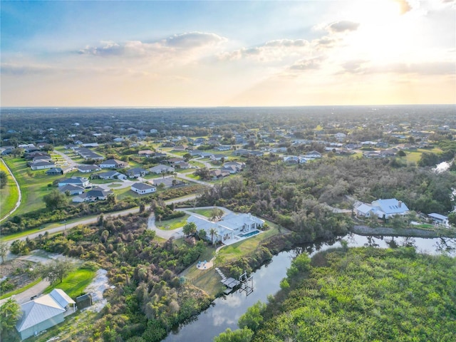 aerial view at dusk with a water view