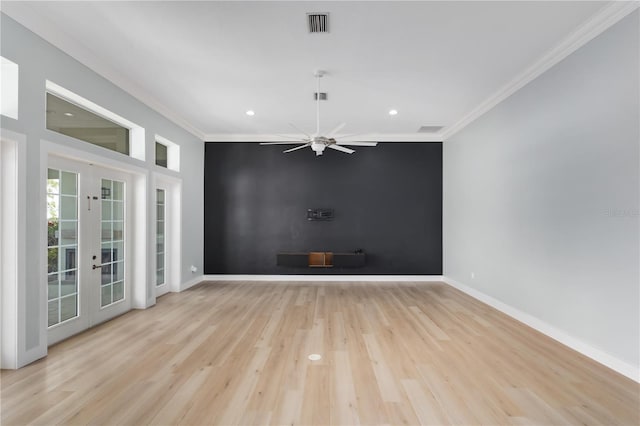 spare room with crown molding, light hardwood / wood-style floors, french doors, and ceiling fan