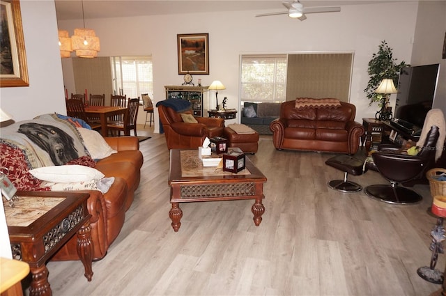 living room with ceiling fan and light wood-type flooring