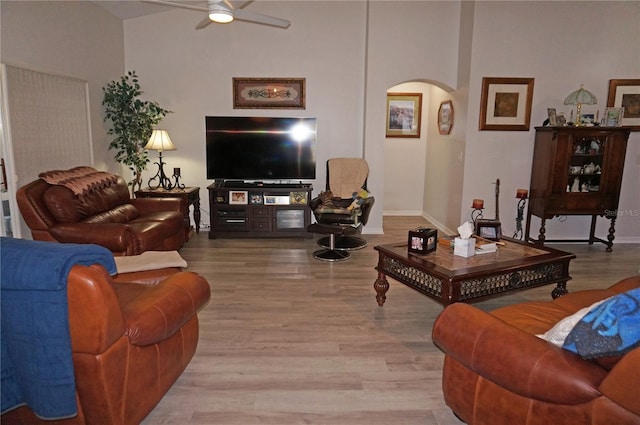 living room with wood-type flooring and ceiling fan