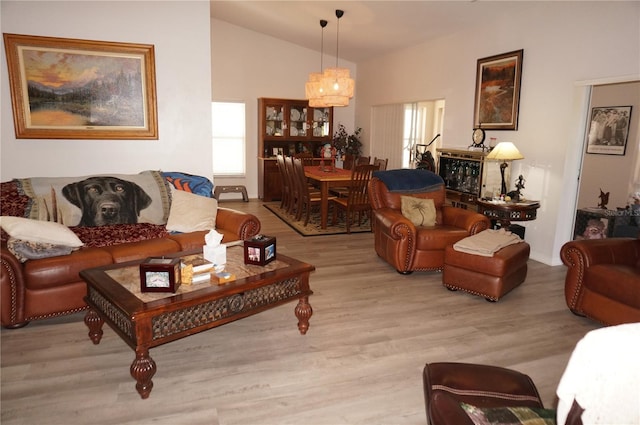 living room featuring vaulted ceiling and light hardwood / wood-style floors