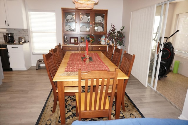 dining space with light hardwood / wood-style flooring