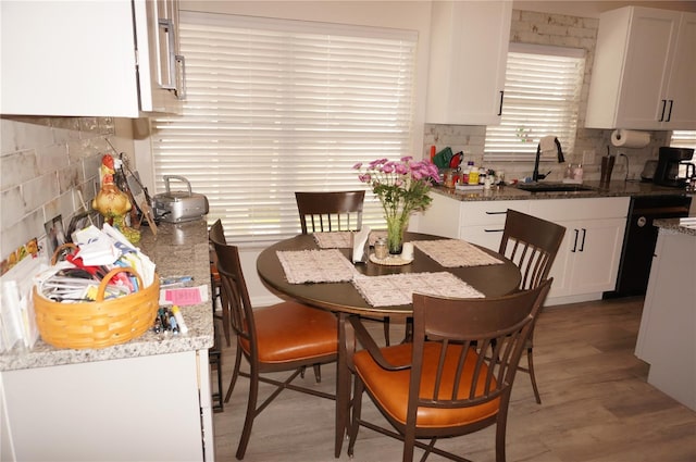 dining space featuring sink and light hardwood / wood-style flooring