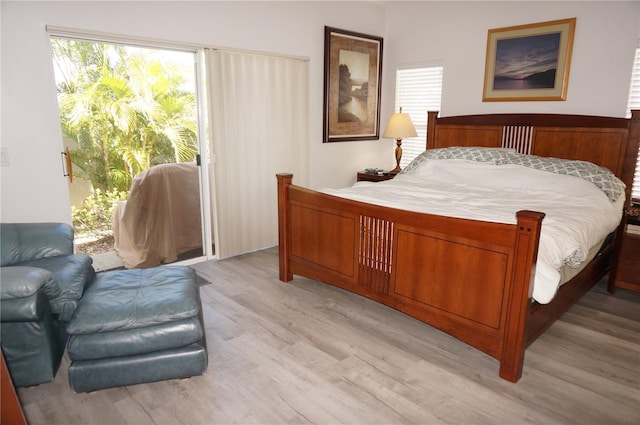 bedroom with access to exterior and light wood-type flooring