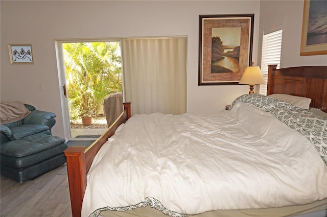 bedroom featuring hardwood / wood-style floors and access to outside