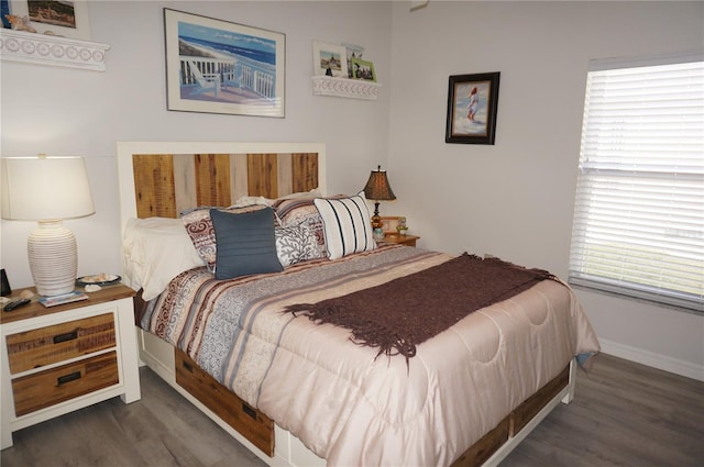 bedroom with dark hardwood / wood-style flooring