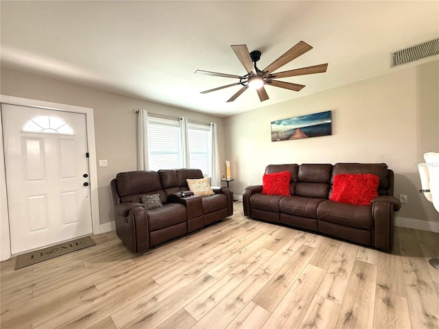 living room with ceiling fan and light hardwood / wood-style floors