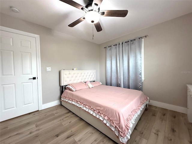 bedroom with ceiling fan and light wood-type flooring