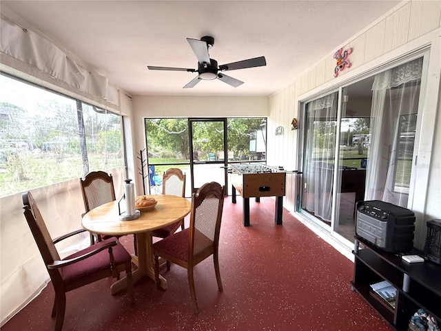 sunroom / solarium featuring ceiling fan