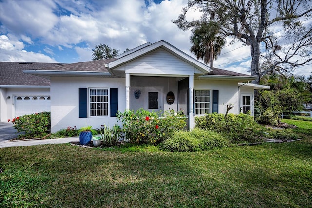 view of front of house featuring a garage and a front lawn