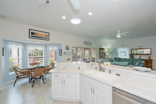 kitchen with light tile patterned flooring, sink, dishwasher, ceiling fan, and white cabinets