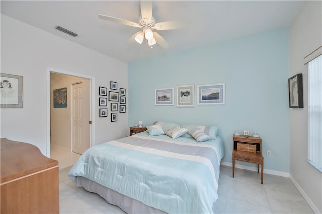 tiled bedroom with ceiling fan