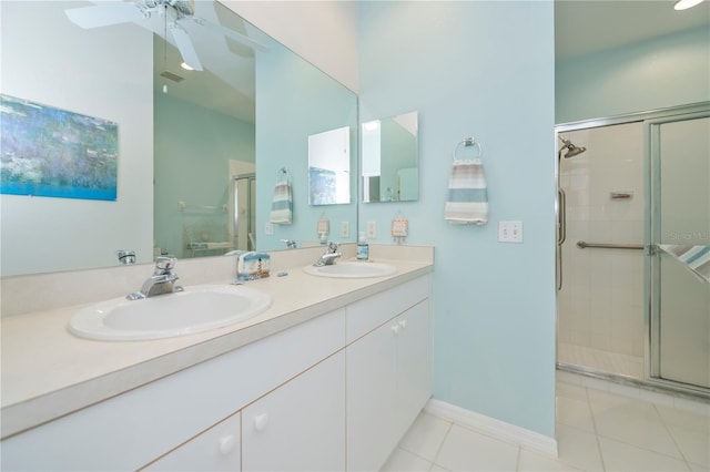 bathroom with tile patterned flooring, vanity, a shower with door, and ceiling fan