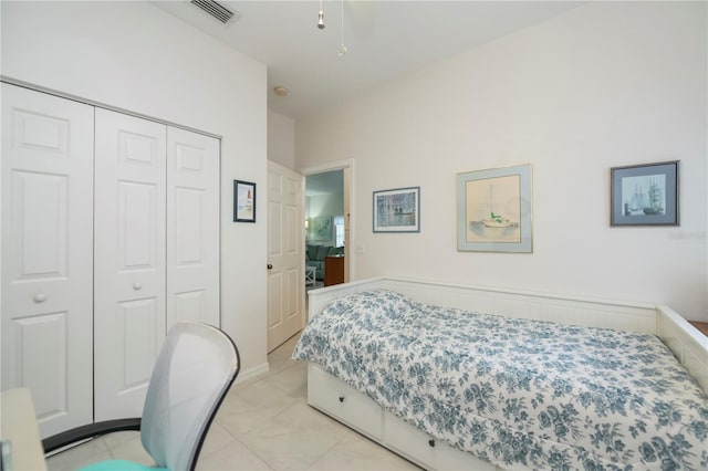 tiled bedroom with a closet