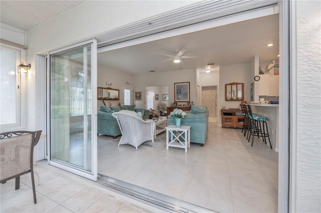 living room with ceiling fan and light tile patterned floors