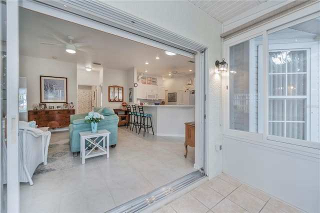 interior space with ceiling fan