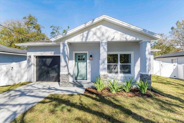 view of front facade featuring a garage and a front lawn