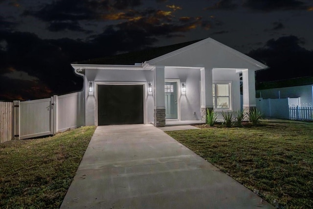 view of front of property featuring a garage and a front yard