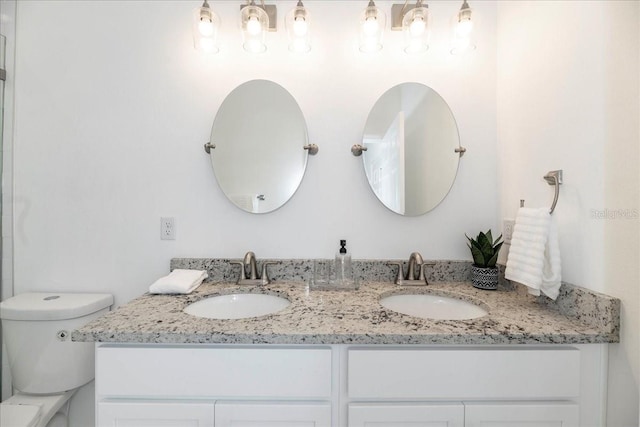 bathroom featuring vanity and toilet