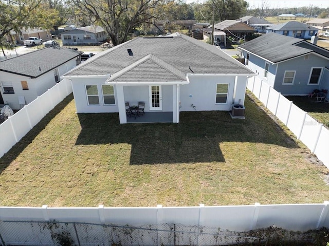 back of property featuring central AC, a patio, and a lawn