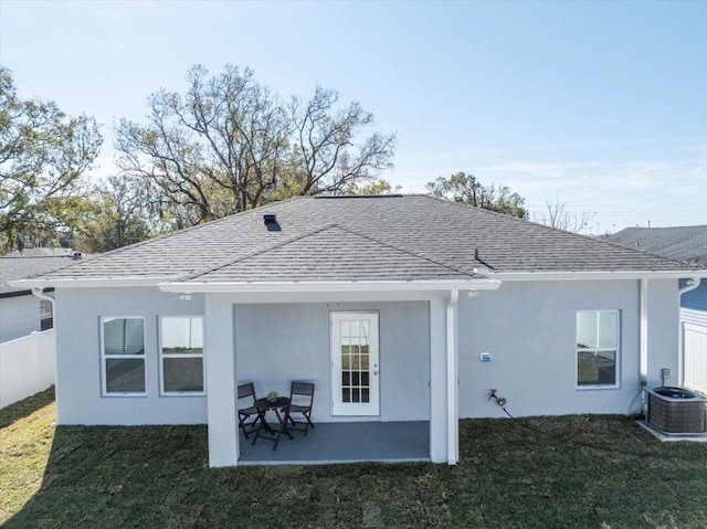 rear view of house featuring central AC, a yard, and a patio area