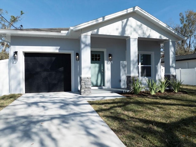 view of front of home featuring a garage, covered porch, and a front lawn