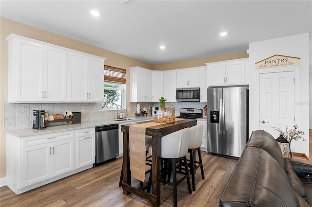 kitchen with appliances with stainless steel finishes, sink, and white cabinets