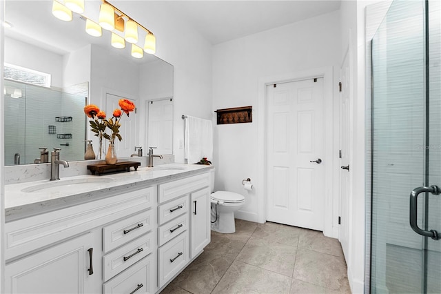 bathroom featuring a shower with door, vanity, tile patterned floors, and toilet