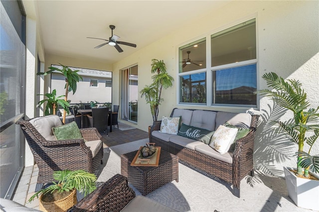 sunroom / solarium featuring ceiling fan