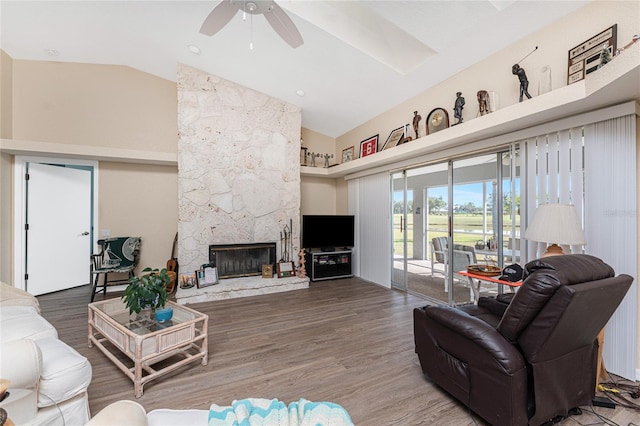 living room with lofted ceiling, a fireplace, wood-type flooring, and ceiling fan