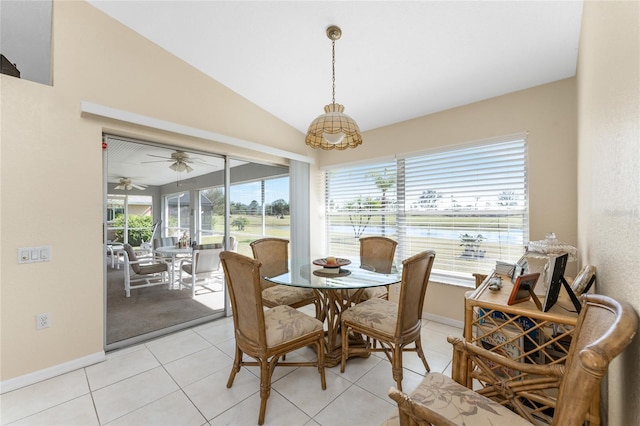 dining area featuring vaulted ceiling and light tile patterned flooring