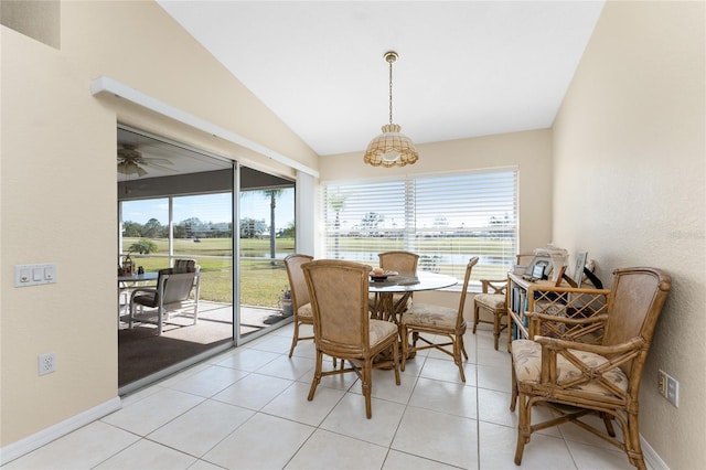 dining space with lofted ceiling and light tile patterned floors