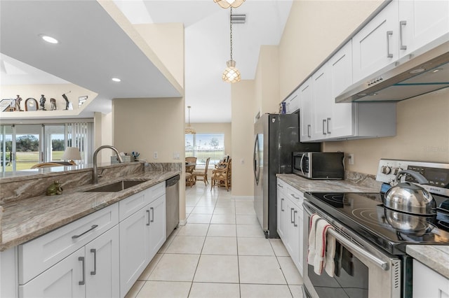 kitchen featuring sink, white cabinetry, hanging light fixtures, appliances with stainless steel finishes, and light stone countertops