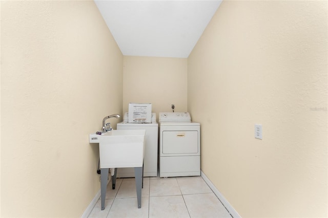 washroom with washing machine and dryer and light tile patterned floors