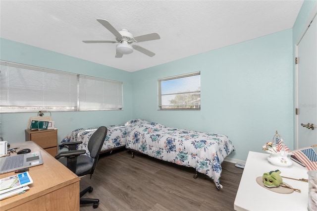 bedroom with hardwood / wood-style flooring, ceiling fan, and a textured ceiling