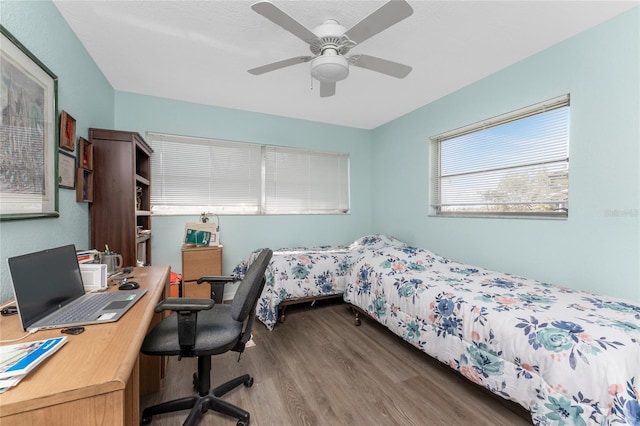 bedroom featuring ceiling fan and dark hardwood / wood-style flooring