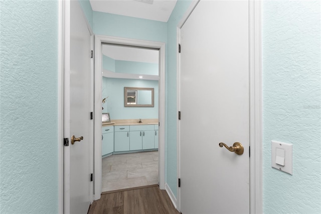 hall with sink and hardwood / wood-style floors